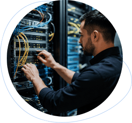 Technician checking organized cables in a server rack.
