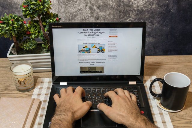 A man reading an article on his laptop