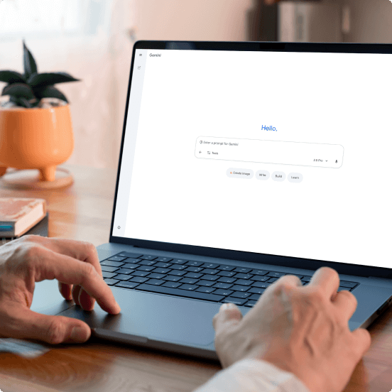 person typing on laptop with Gemini onscreen