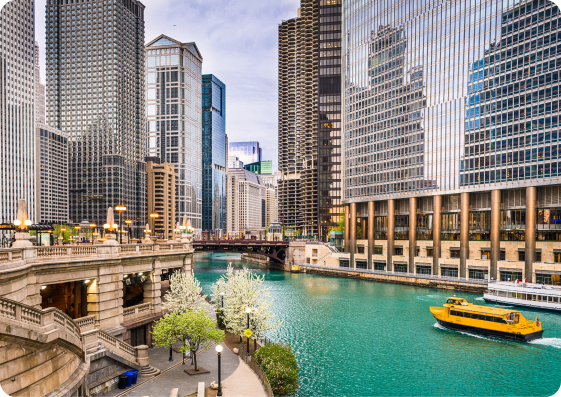 An area of Chicago, Illinois, featuring high-rise buildings and a boat on the river