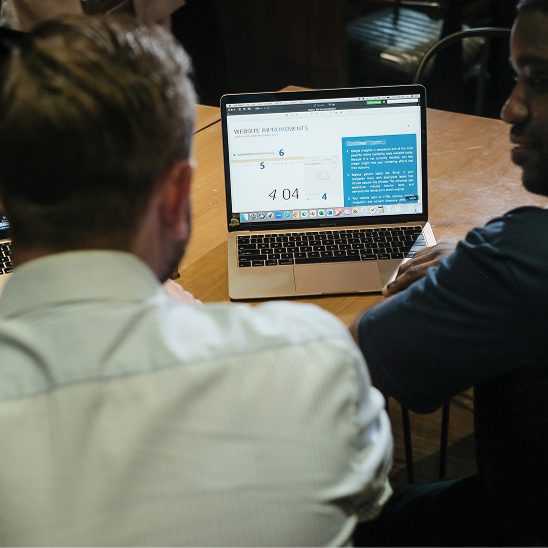 Coalition Technologies team reviewing a project scope document and requirements together on a laptop