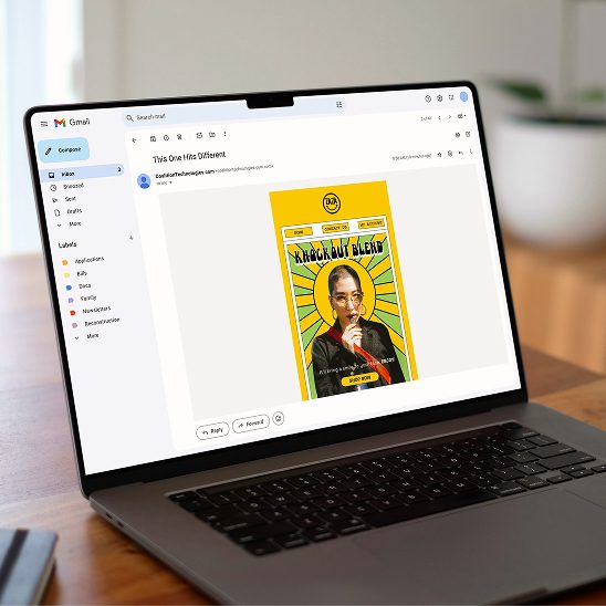 Laptop on desk displaying Gmail interface with a bold yellow promotional email design open on screen