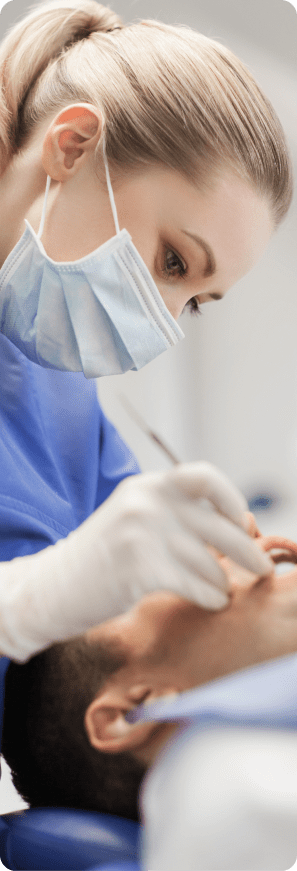 Dentist performing treatment on a patient in a clinical dental setting