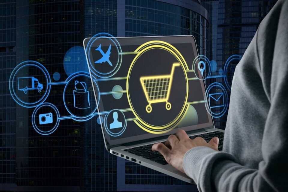A website developer holding an open laptop with overlaid graphics illustrating ecommerce and AI search categories