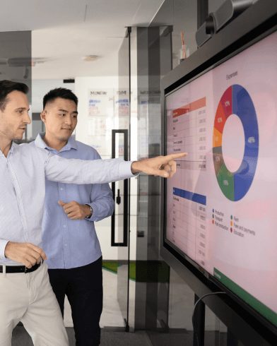 two guys discussing charts and expanding tech solutions