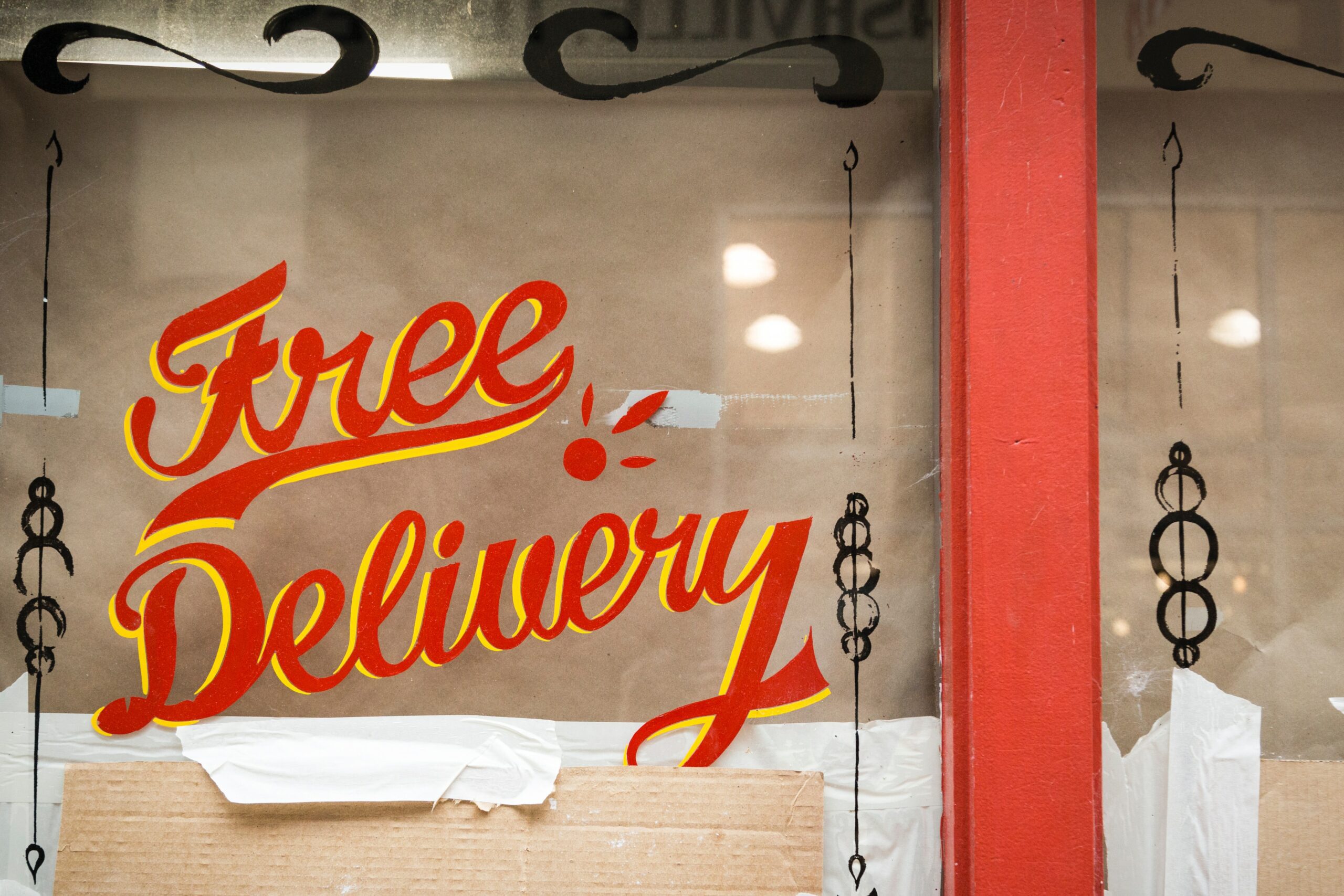 a free delivery sign in a store window