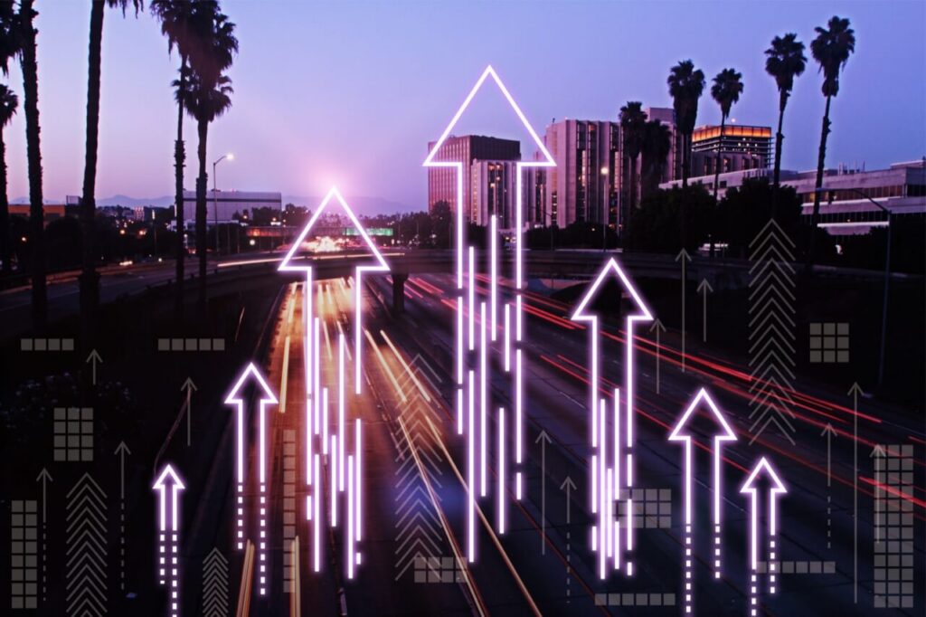 A twilight view of Los Angeles with upward arrows overlaid
