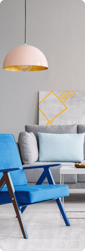 Modern living room with blue accent chairs, gray sofa, pendant light, and wall art.