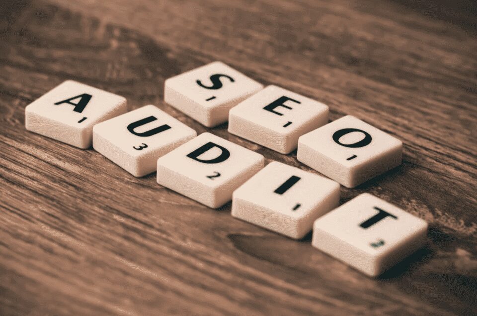 Game pieces organized to spell out SEO audit