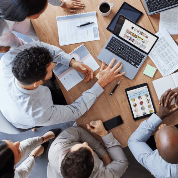 group facing a devices displaying an Etsy store