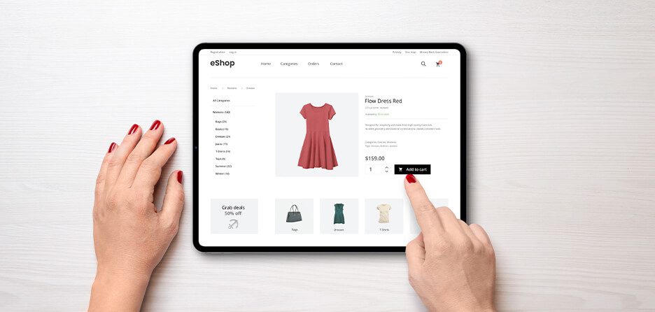 hands holding a tablet displaying a women's fashion boutique product page
