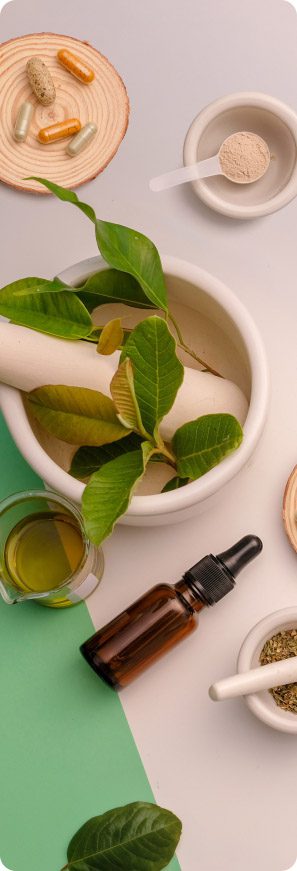 Wellness ingredients and supplements arranged with capsules, powder, leaves, oil, and mortar bowls.