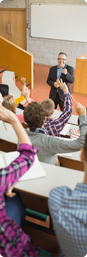 Professor addressing a lecture hall of university students raising their hands