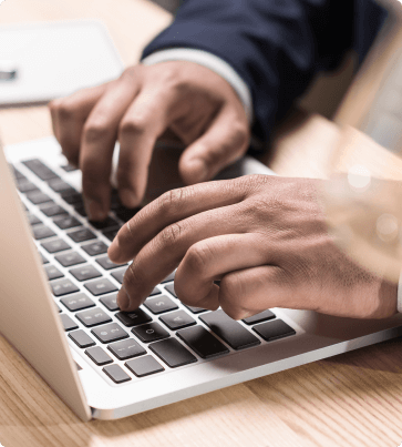 hands typing on laptop