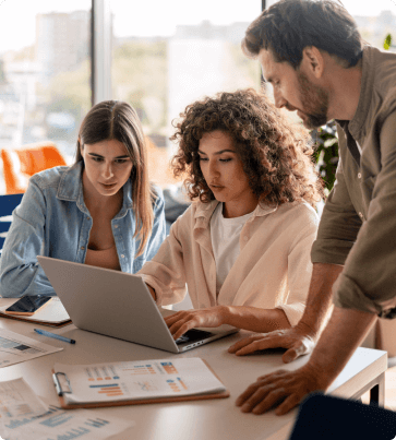 team of people in front of laptop