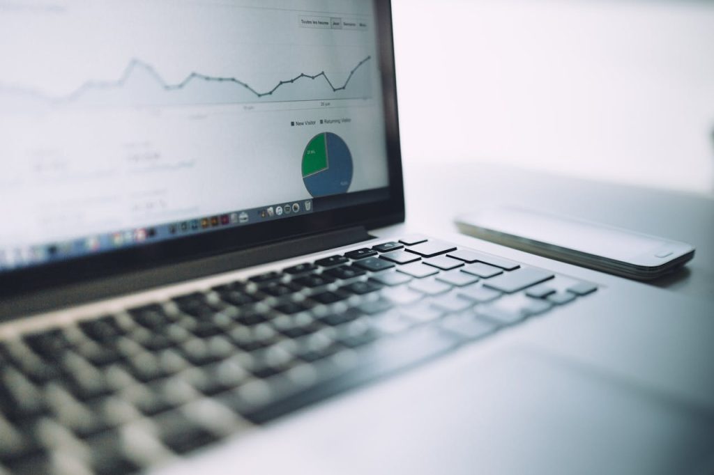 Laptop displaying website analytics graphs and pie chart