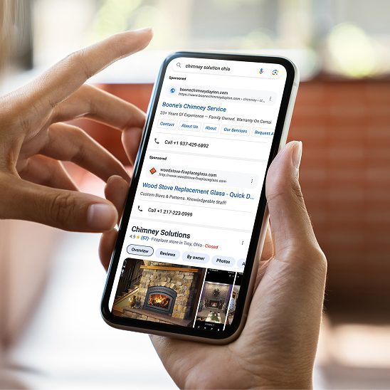 Person viewing local business search results and map listings on a smartphone