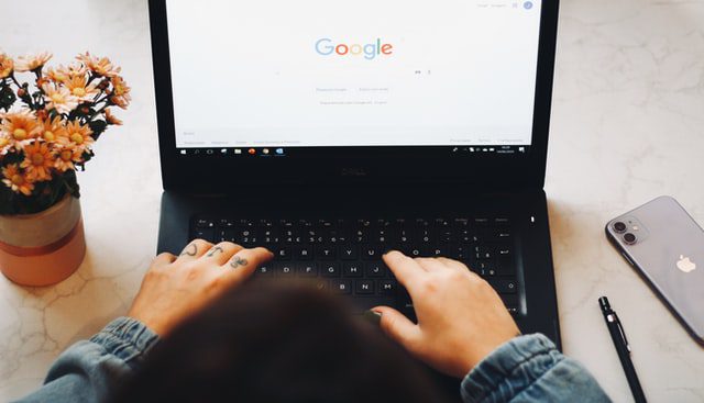 Person using Google on a laptop