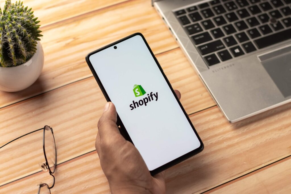 A person using Shopify on their phone.