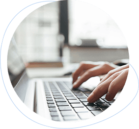 Close-up of hands typing on a laptop keyboard