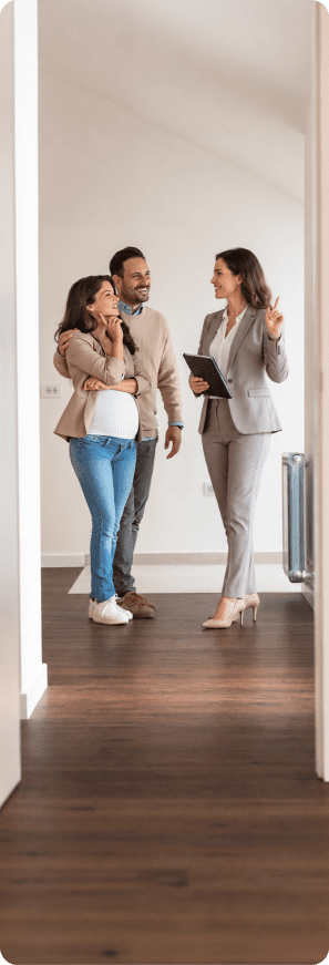 Real estate agent gives a couple a tour of a bright residential property.