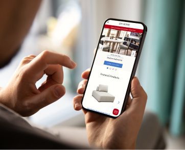 Person using a smartphone to browse an ecommerce site interface designed for responsive design across devices