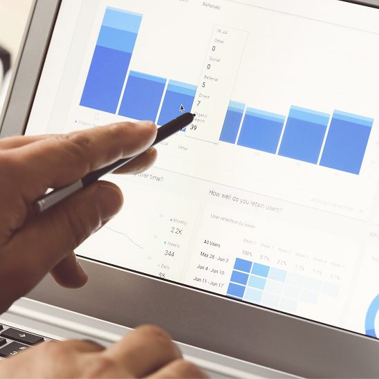 Person analyzing website analytics and traffic charts on a laptop for SEO search engine optimization