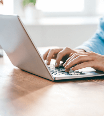 hands typing on a laptop