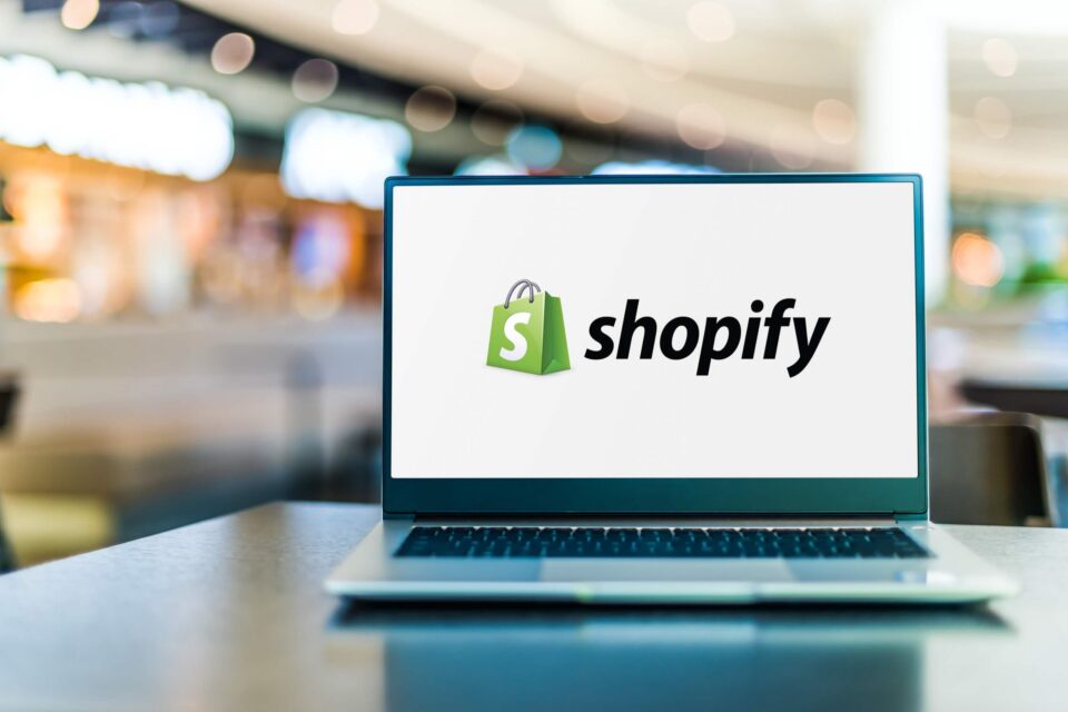 Shopify on a laptop in a shopping area