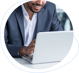 Professional using a laptop and smiling while reviewing project work online