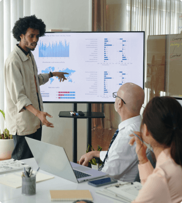 man presenting data to team