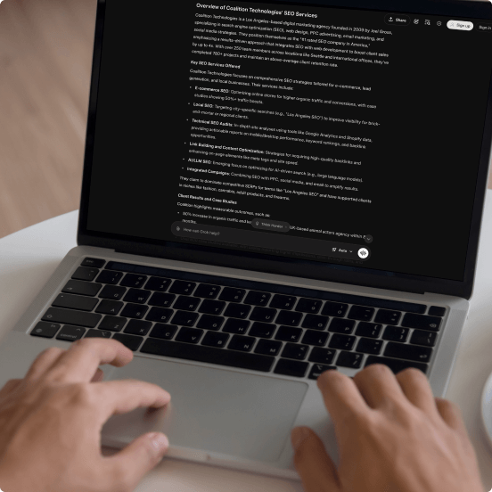 person typing in Grok on laptop